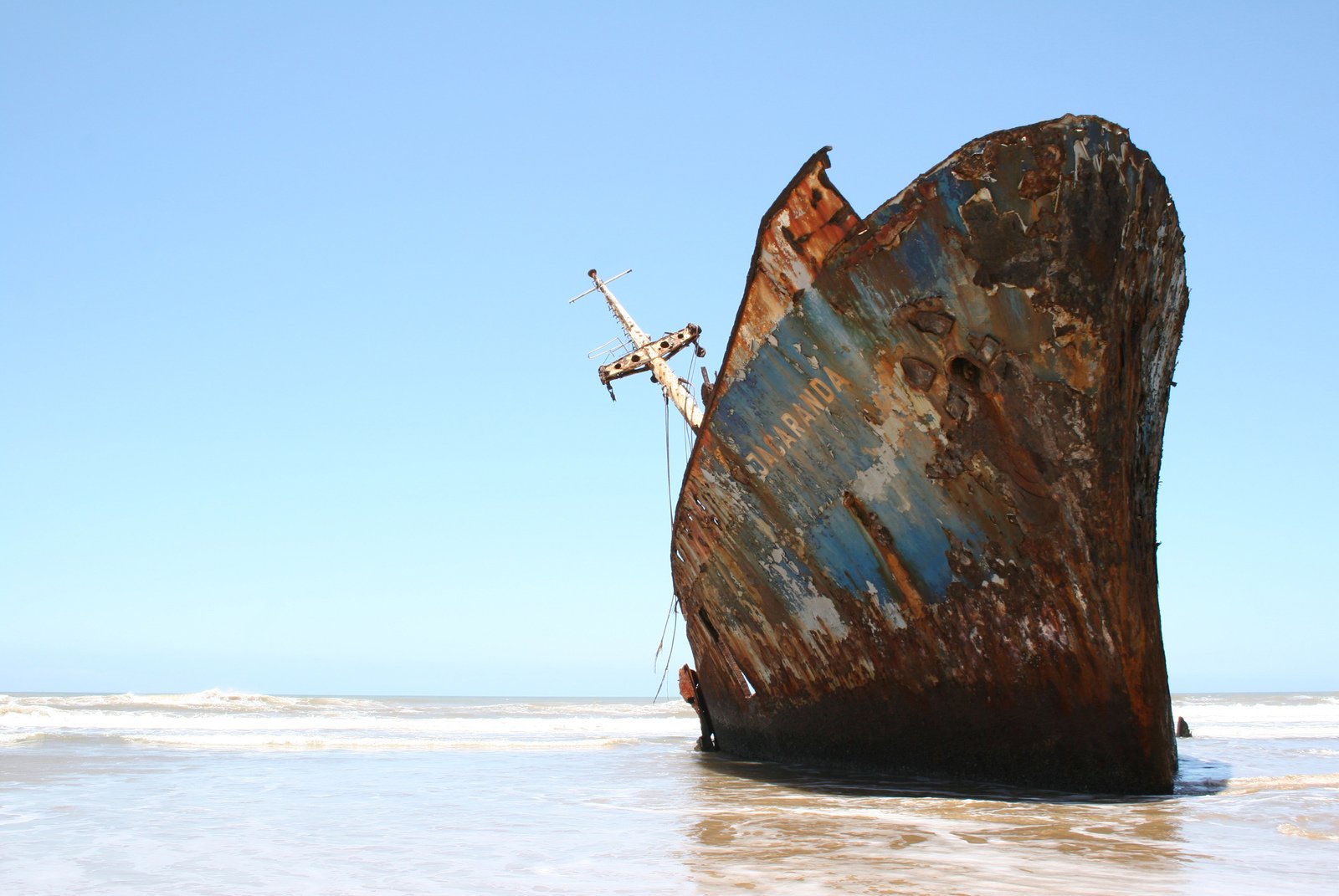 there is a broken ship on the shore