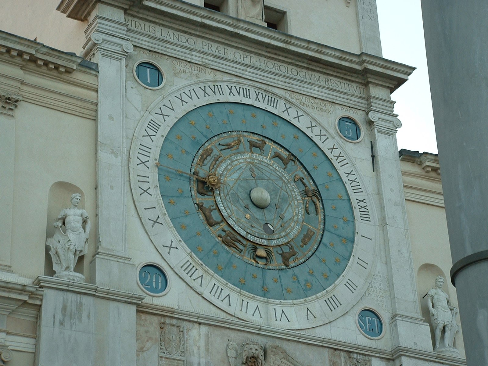 a large clock tower decorated with the zodiac and sundials