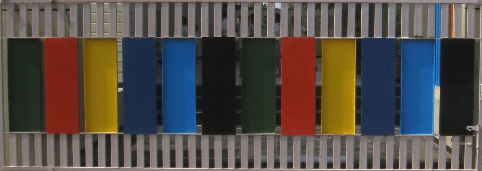 a metal wall with brightly colored windows on it