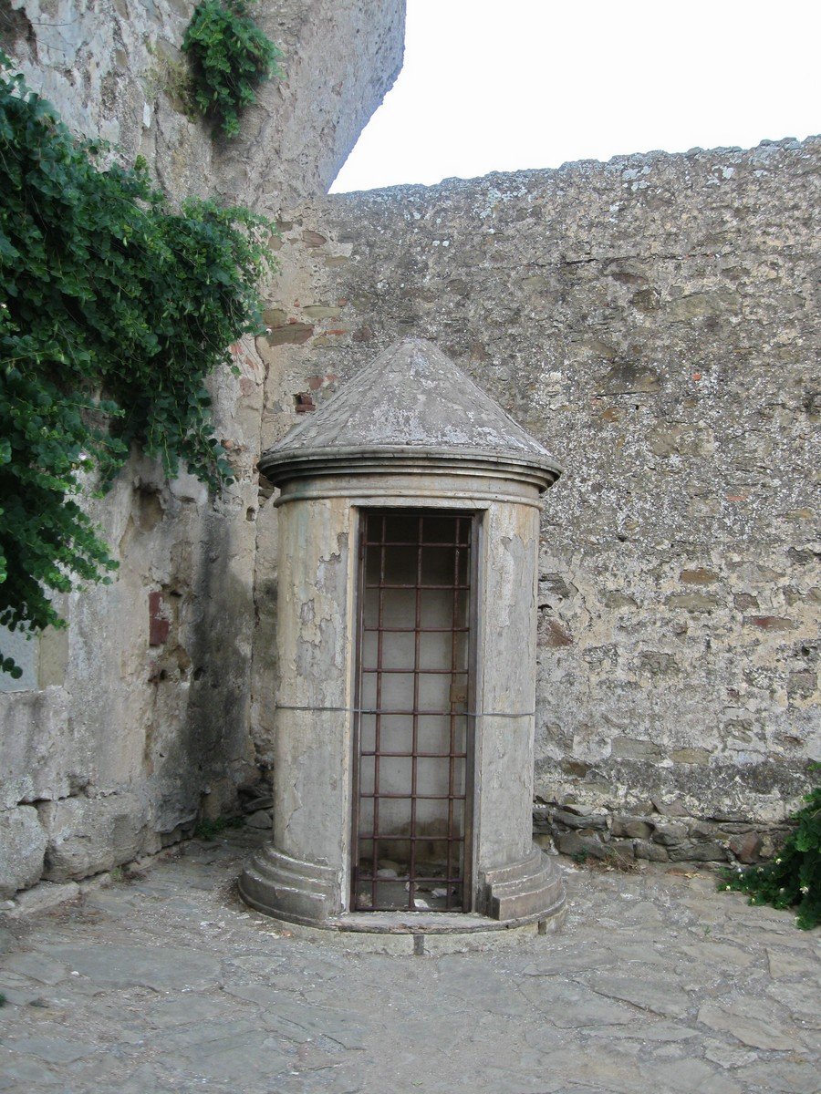 an outhouse with a stone door next to it