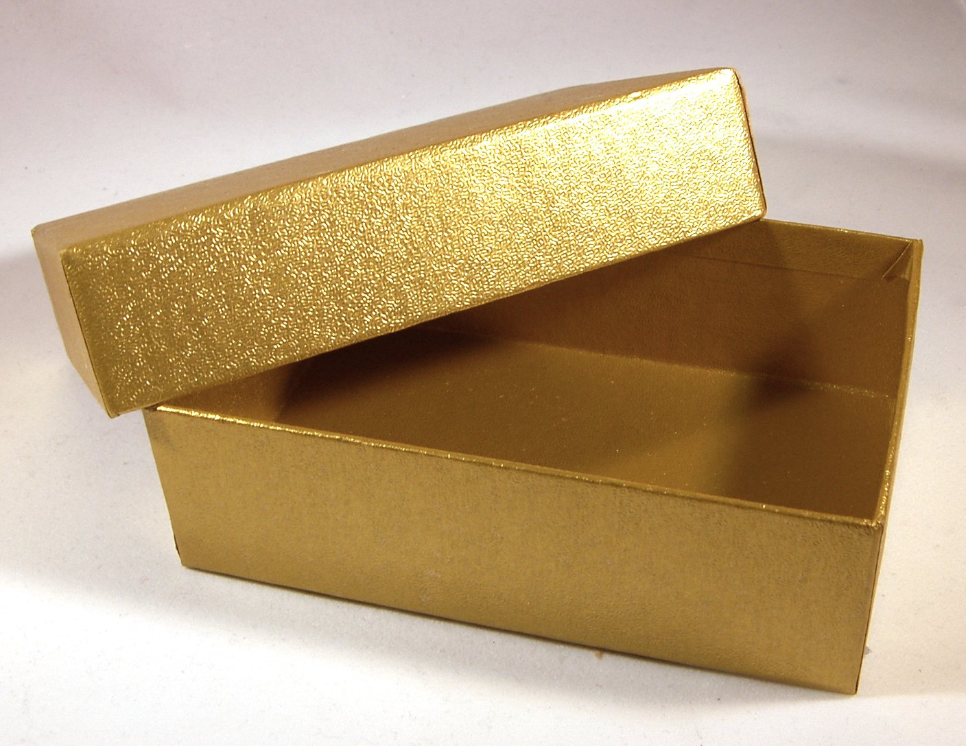 a large, shiny gold gift box on a white background