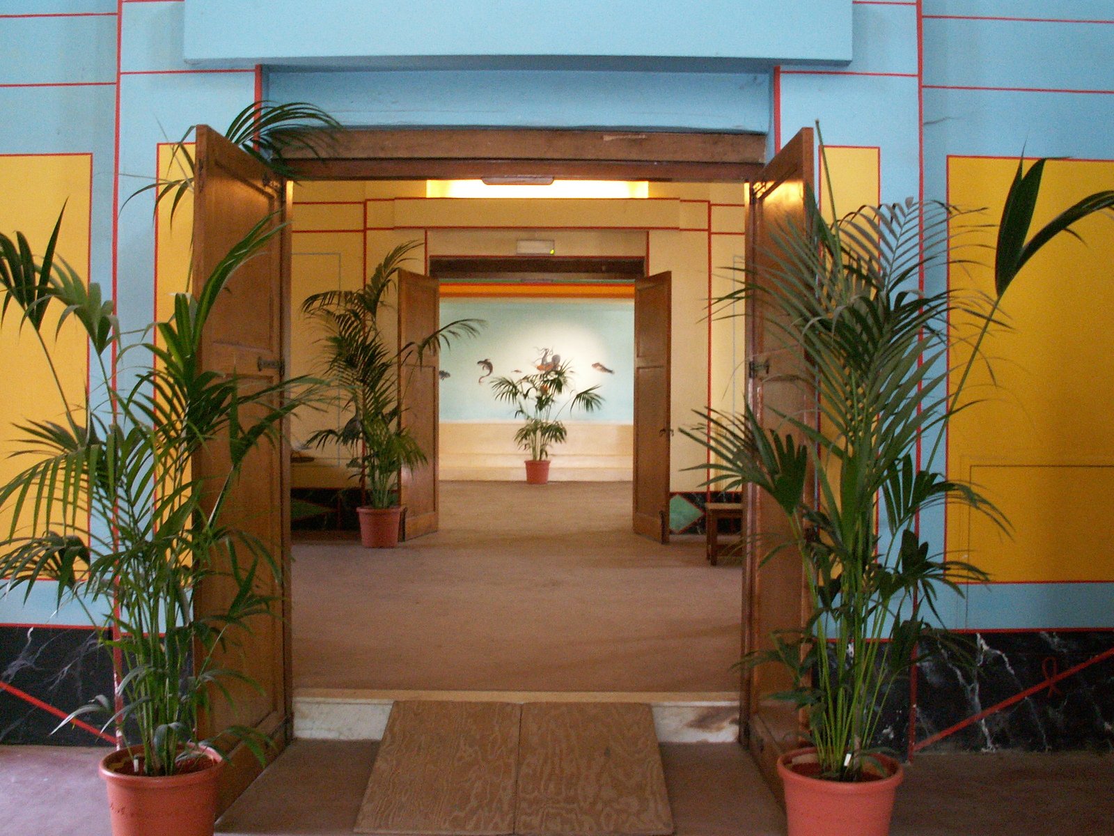 a small corridor with some house plants and potted trees