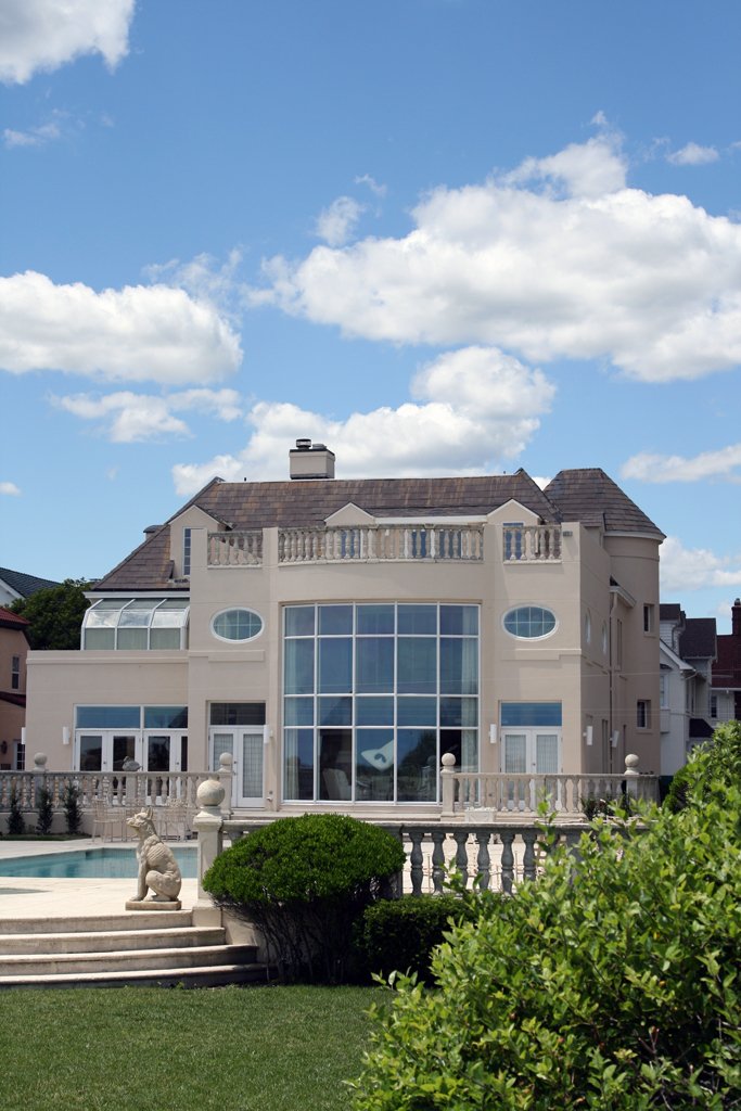 a large house with a pool in front of it