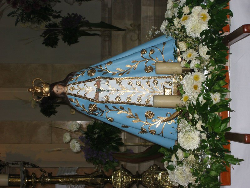 a large blue vase with flowers and a cloth on it