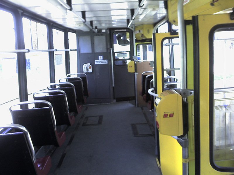 a view of the inside of a bus with doors open