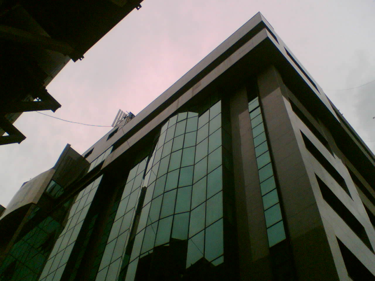 looking up at the side of an office building in a city