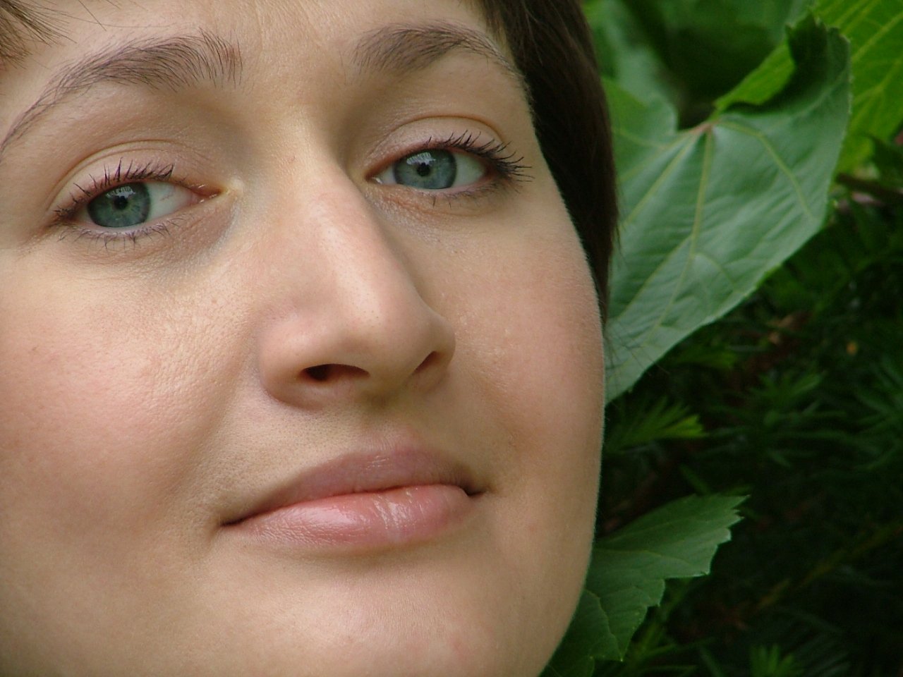 a woman is posing for the camera wearing green