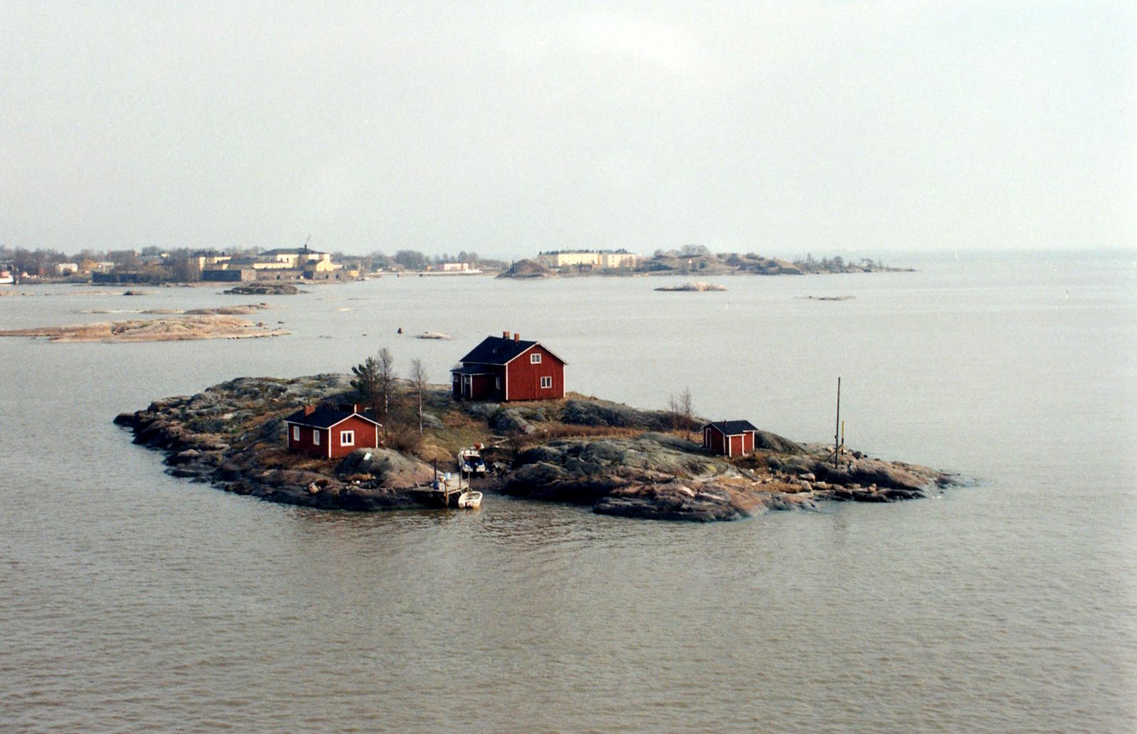 red huts on small island next to water