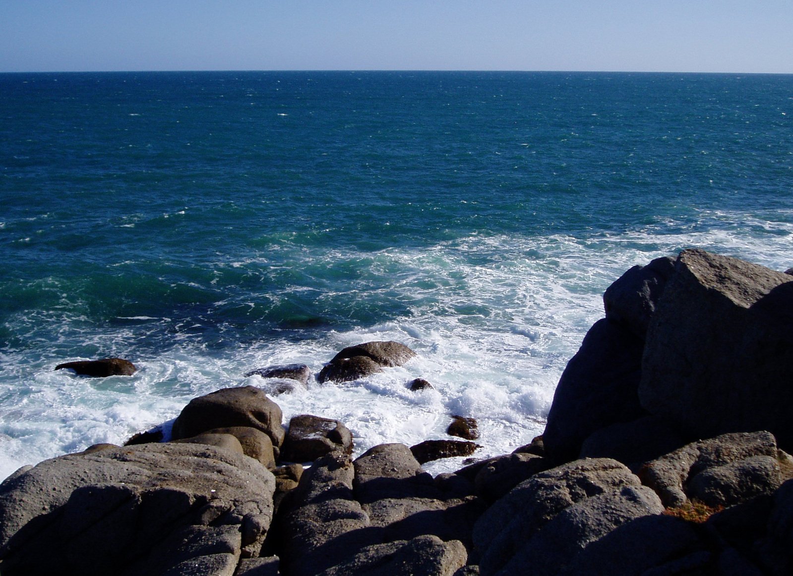 water waves hitting rocks by the shoreline