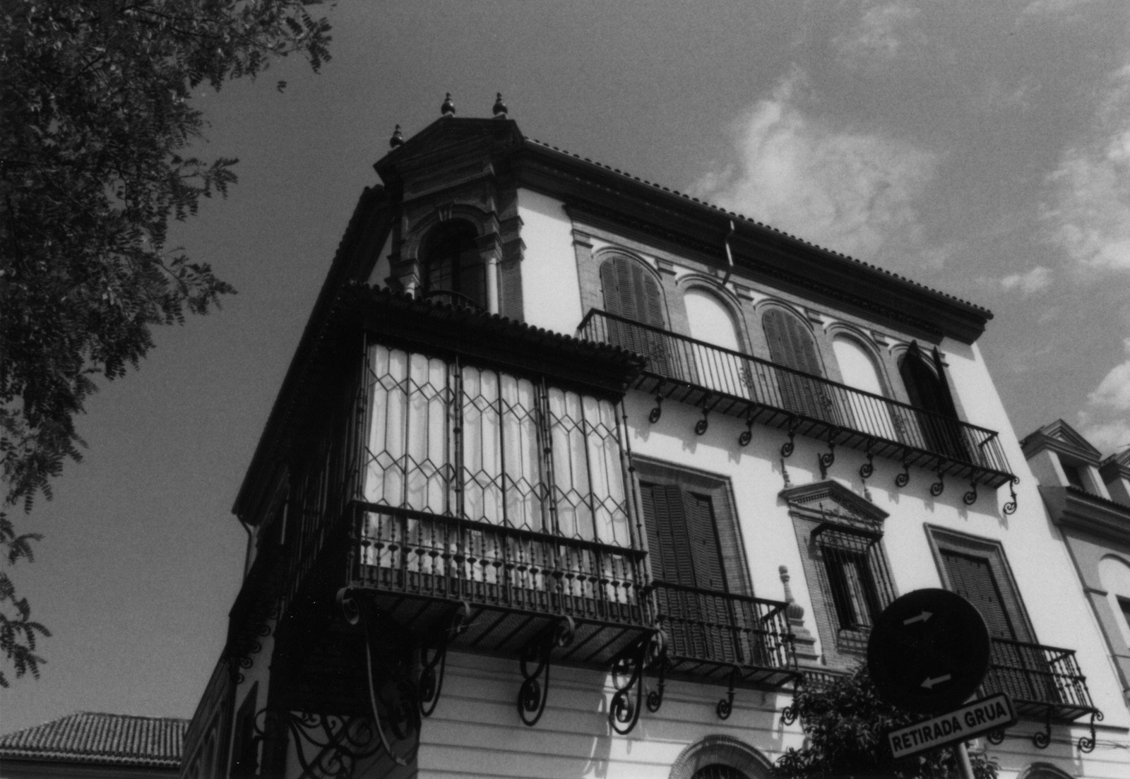 black and white po of a historic building with balconies and wrought iron railings
