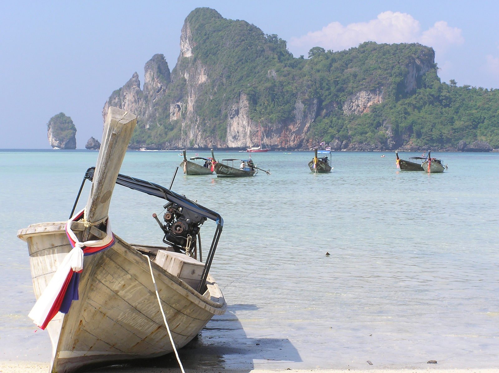 several boats that are docked at the beach