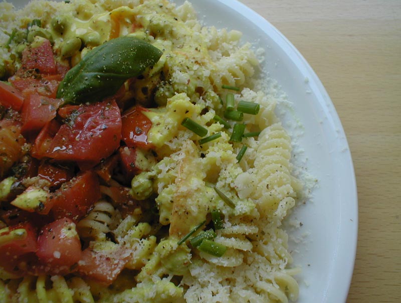 a dish on a white plate filled with pasta and vegetables