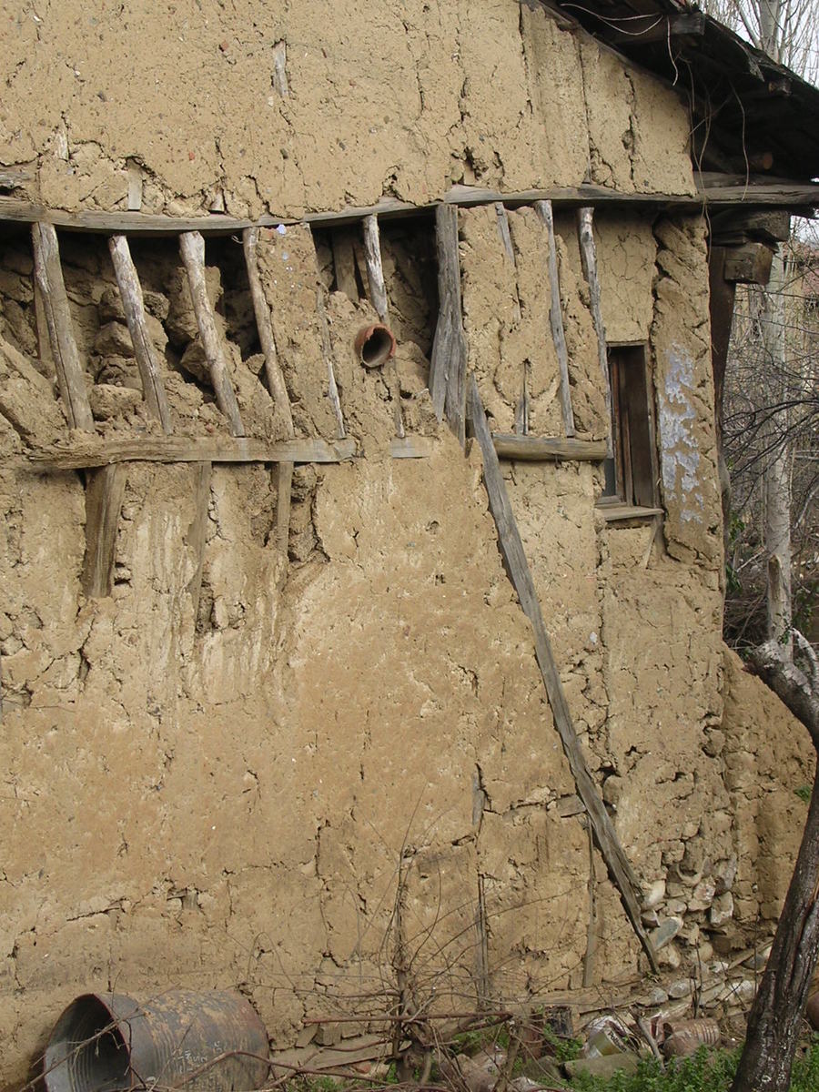 an old building that has been damaged off and has a fence around it