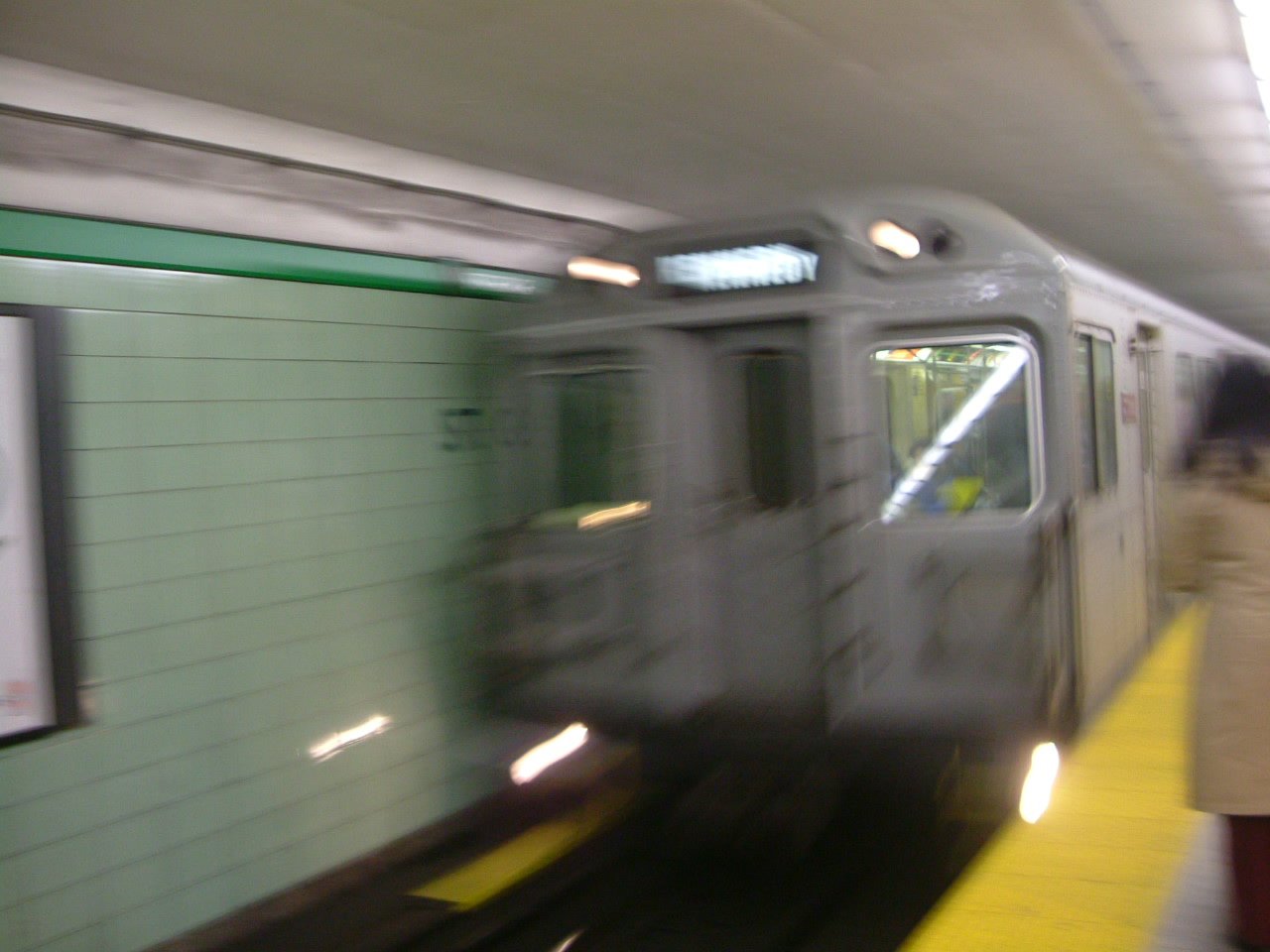 a passenger train is approaching the subway platform