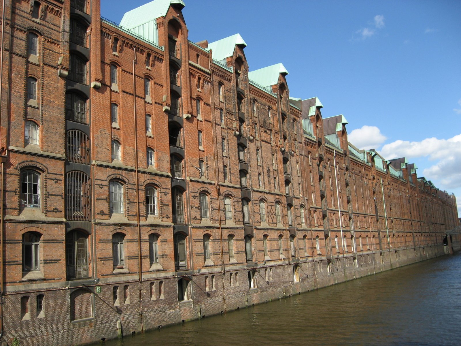 this is an image of large brick buildings on the side of a river
