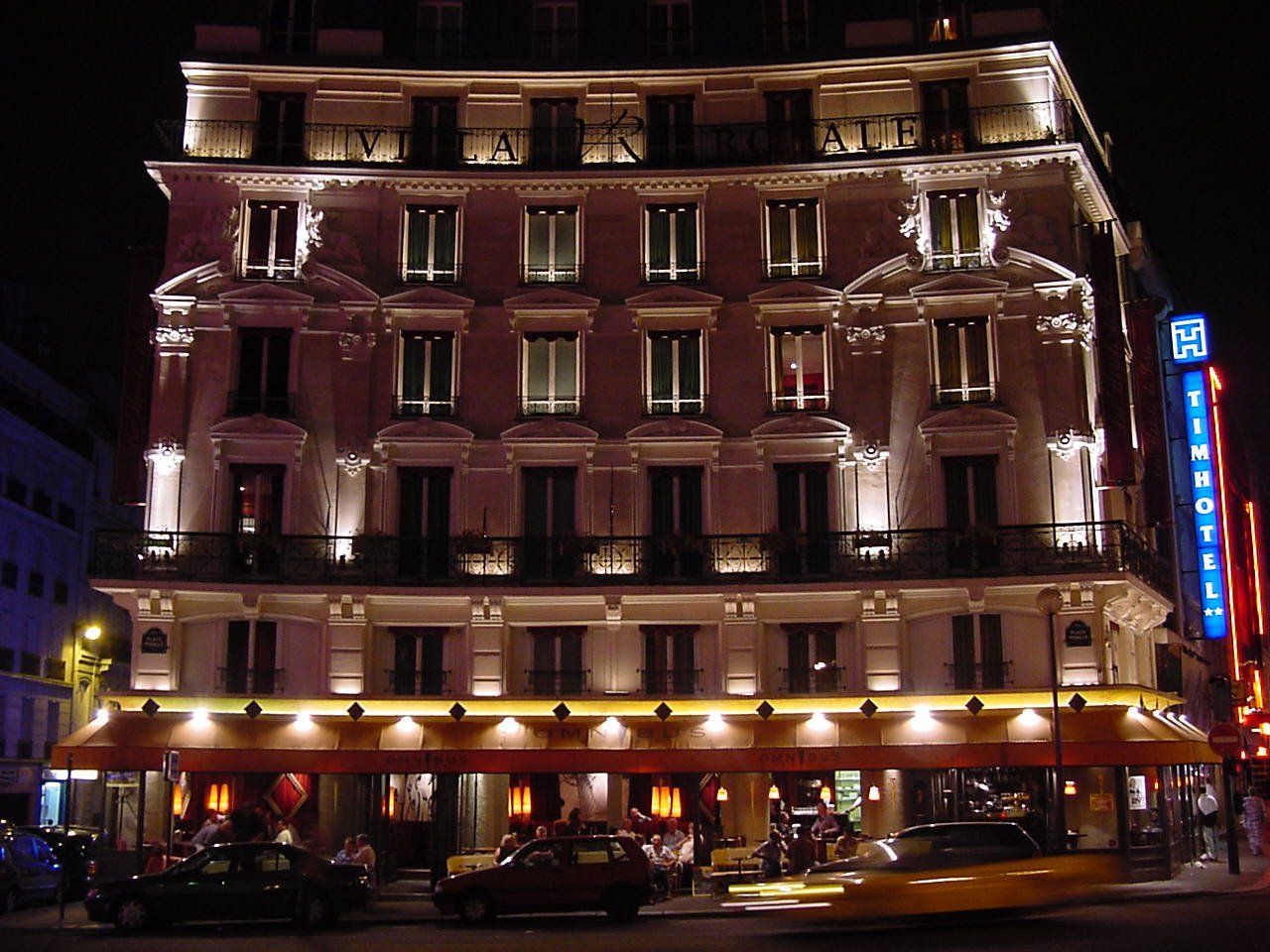 an apartment building at night with several lights on