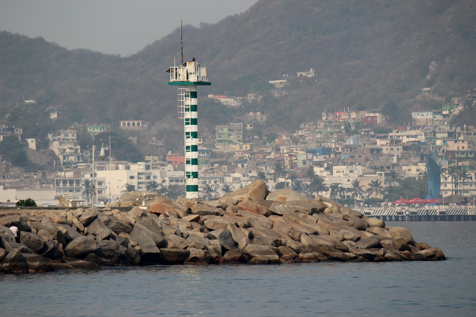 the tall structure stands next to the ocean