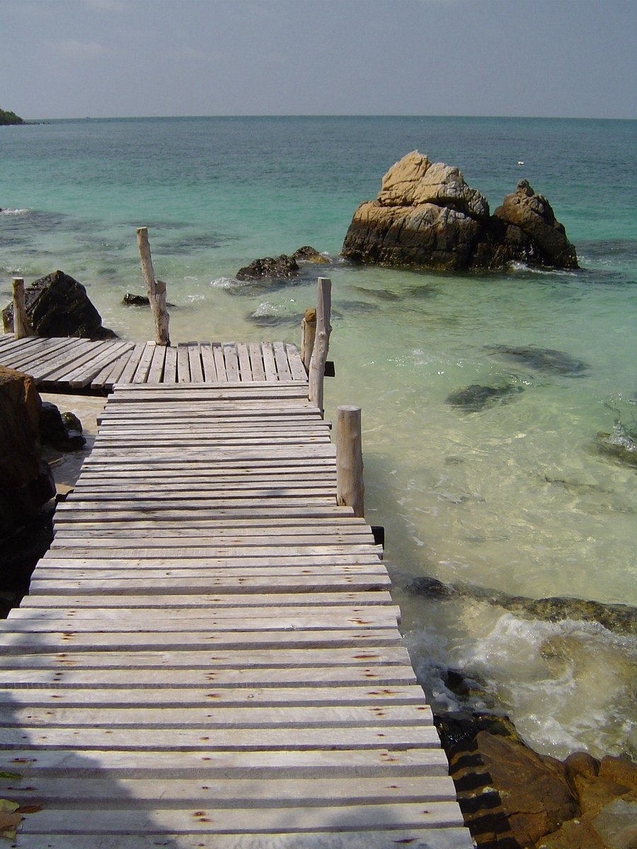 a wooden pathway leading to the beach