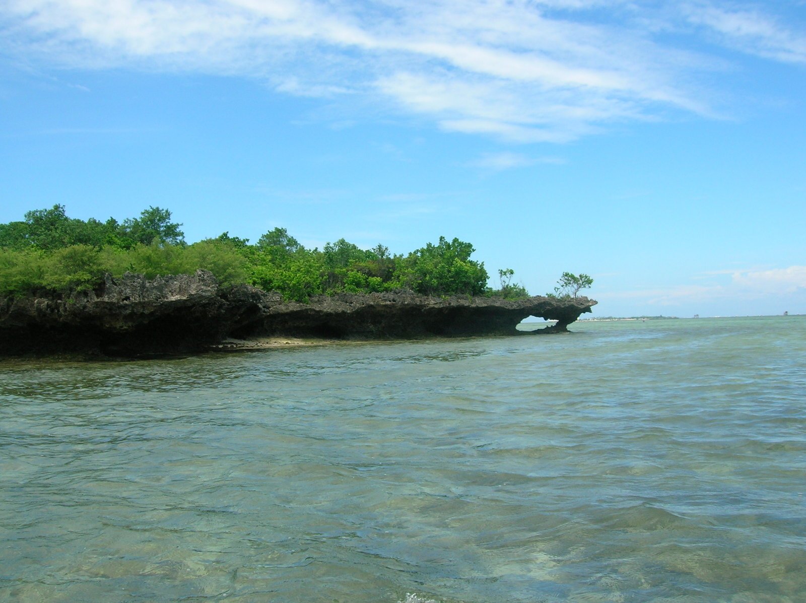 the sea is calm, and there are little ripples in the water