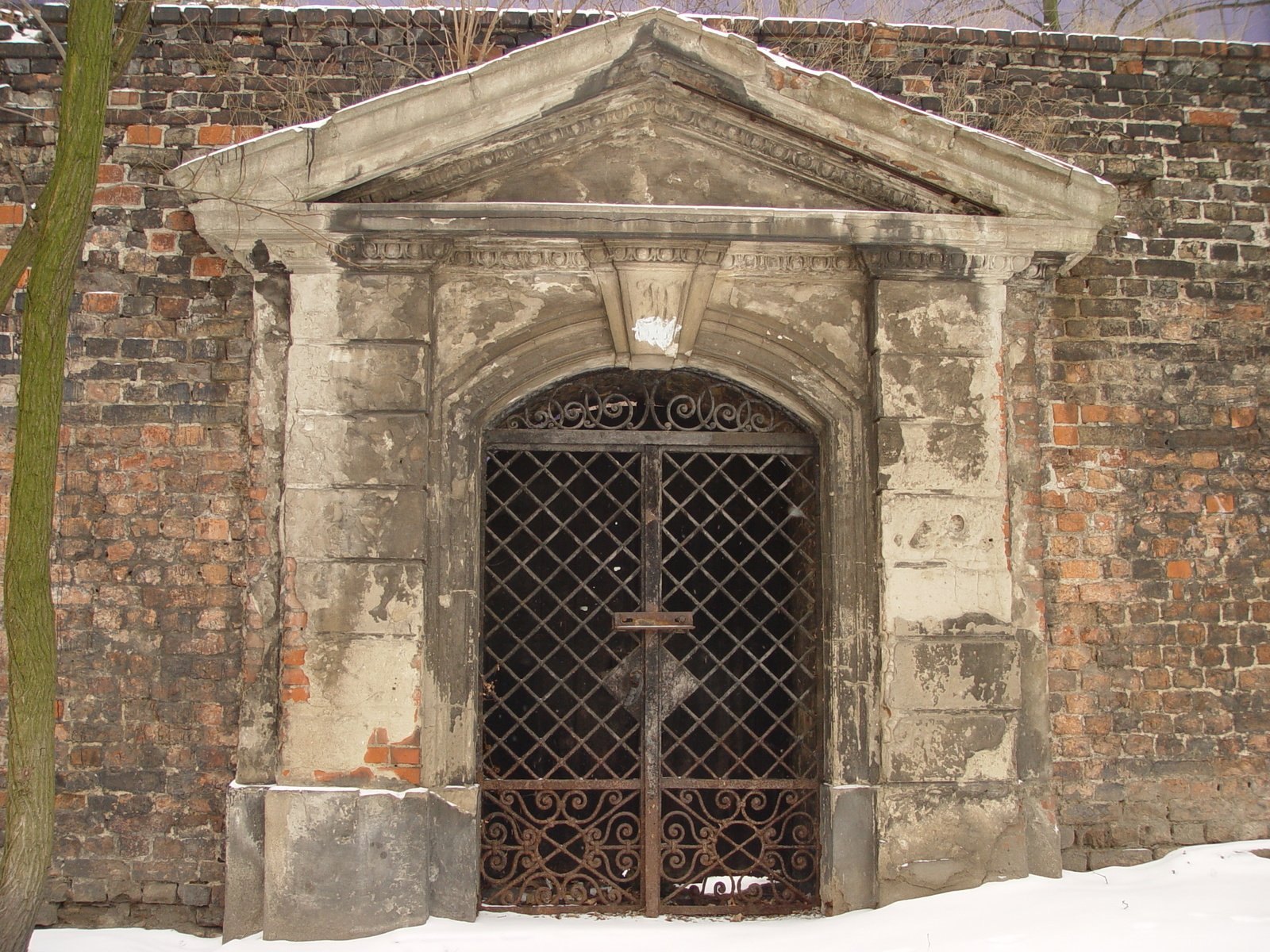 a door sits between two buildings that have snow on them