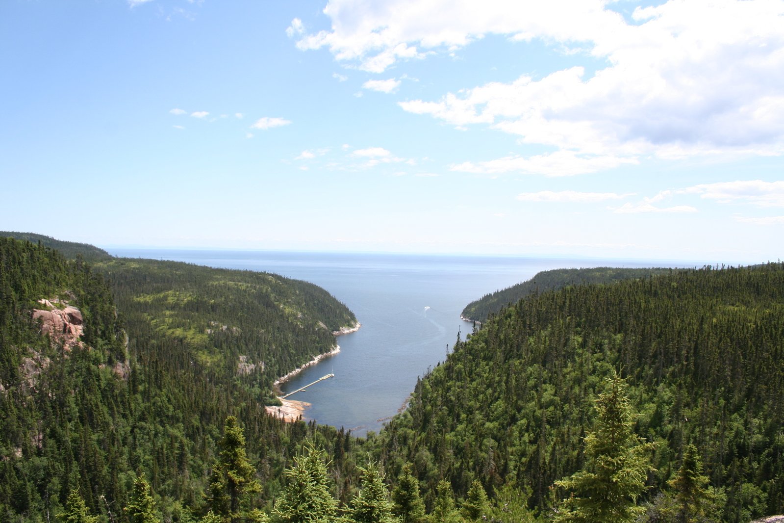 a view of a large lake from the top of a hill