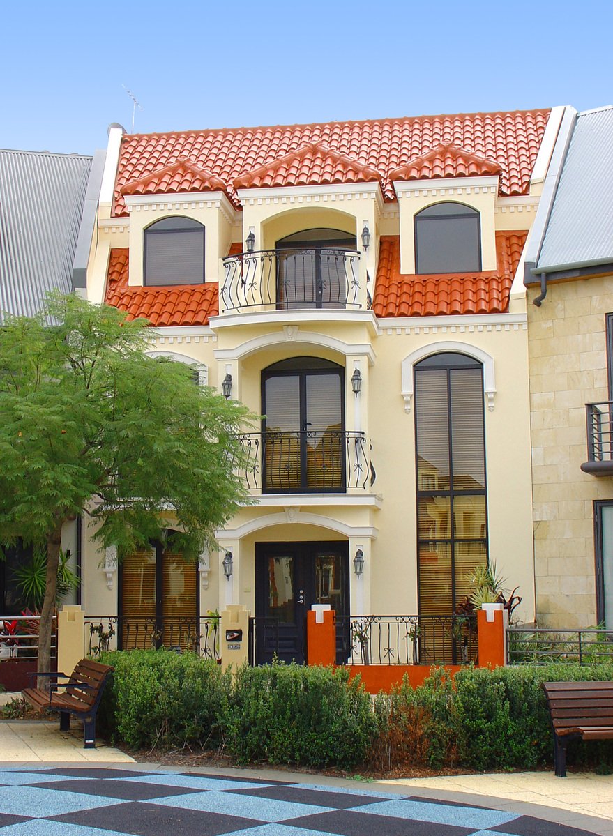 the exterior of this home is painted white and orange