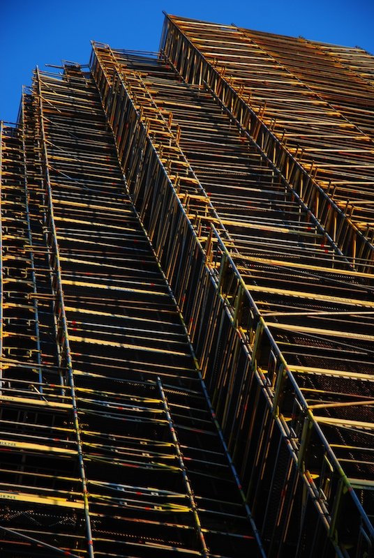 large tall building with wooden boards on the side