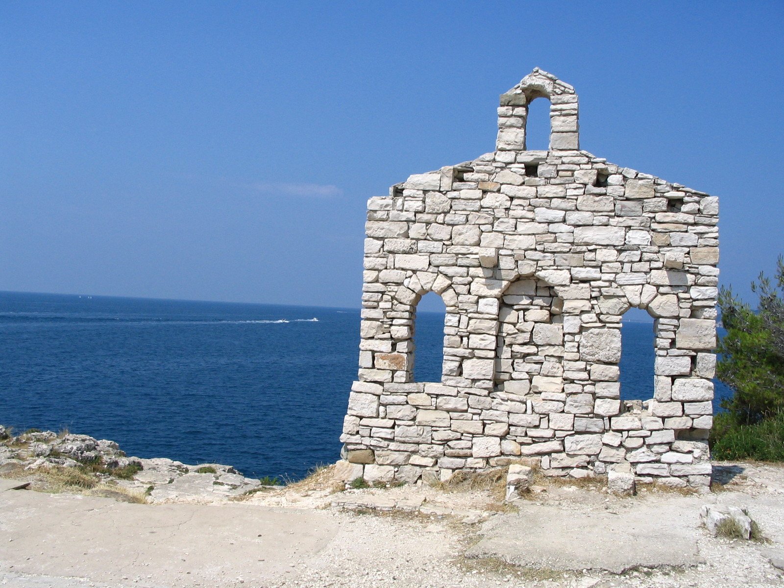 a tower made out of brick near a body of water