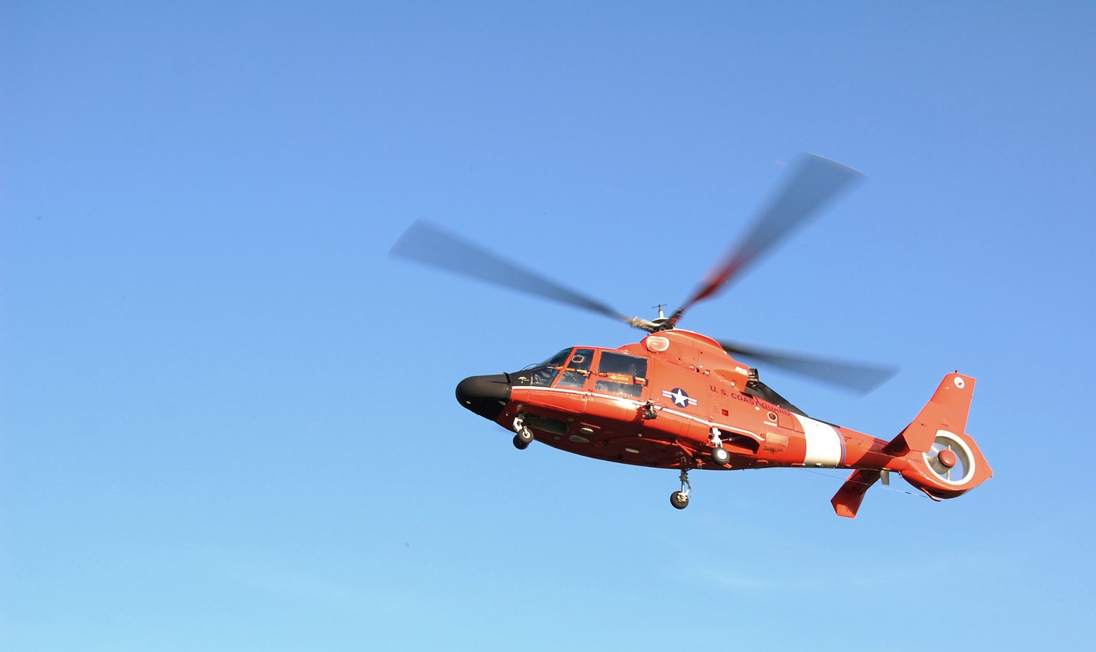 a helicopter flying in the sky during a clear day