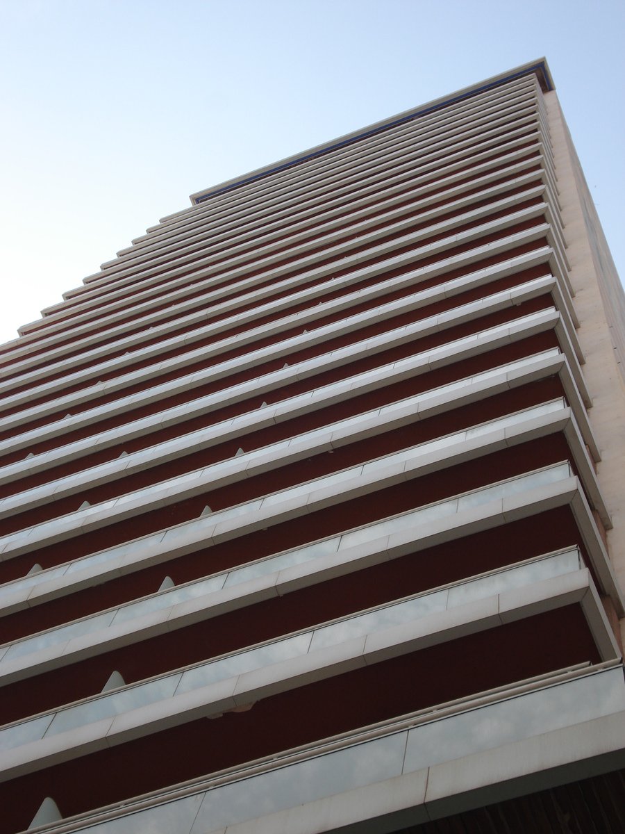 a large brick building with white balconies on it