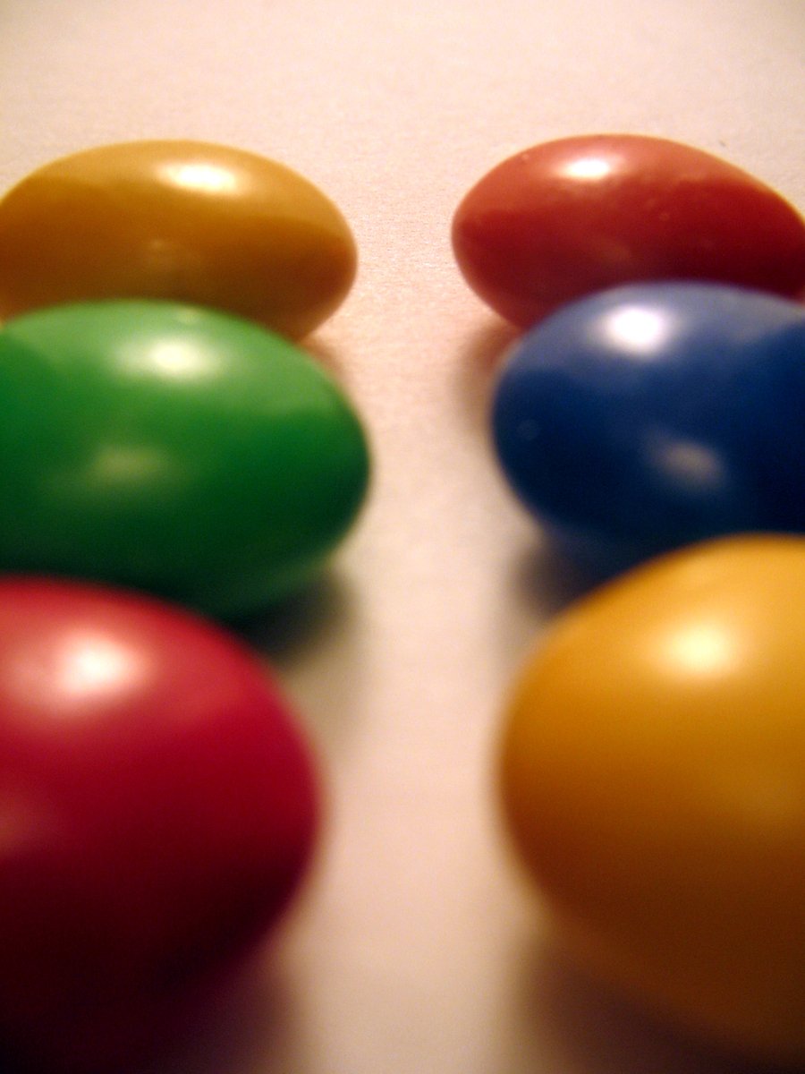 colorfully painted chocolate eggs sit on a counter