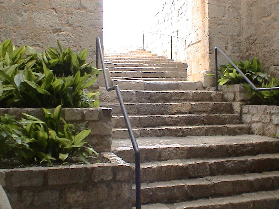 a stairway with several stones leading up to a doorway