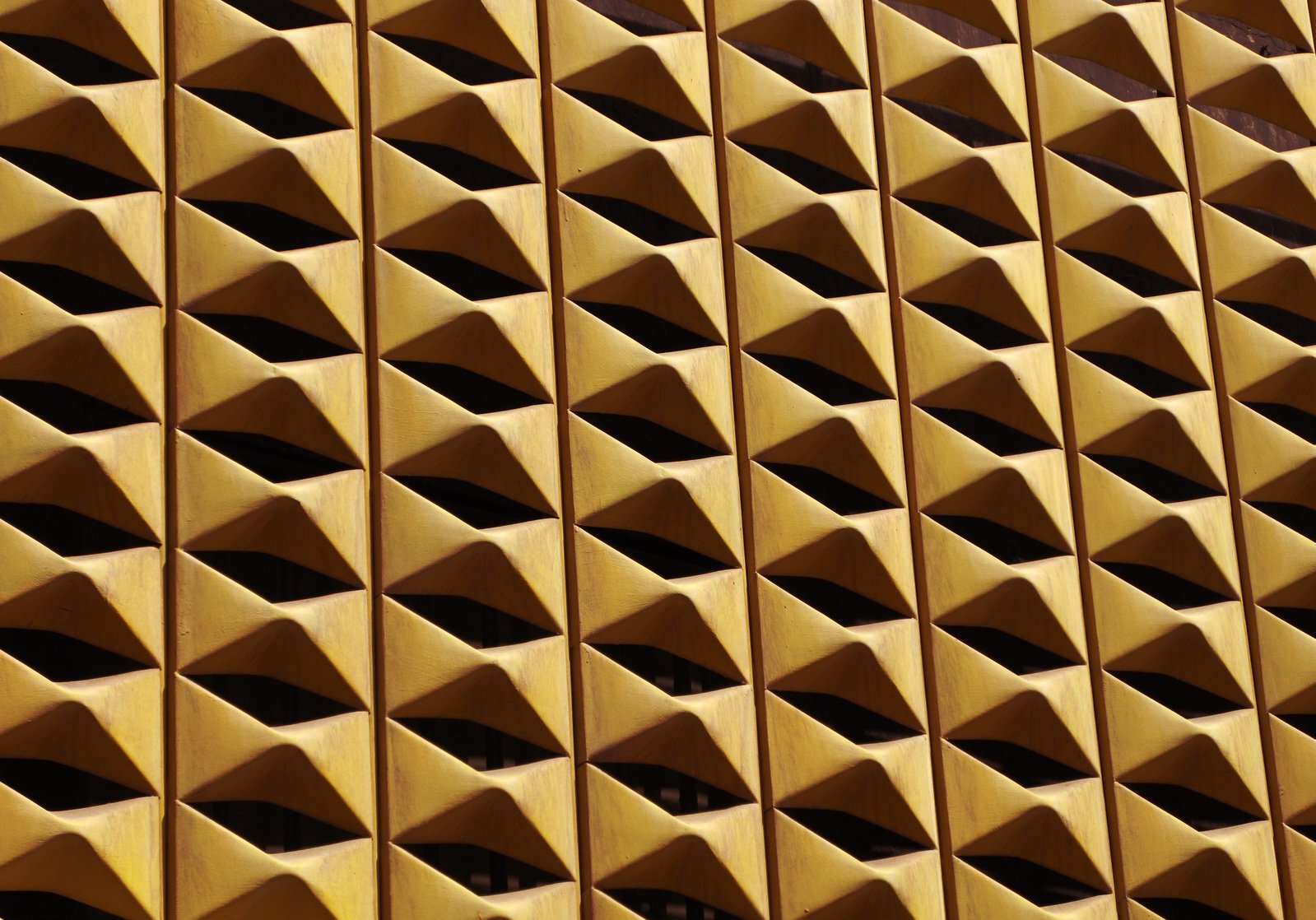 a yellow surface features triangular patterns