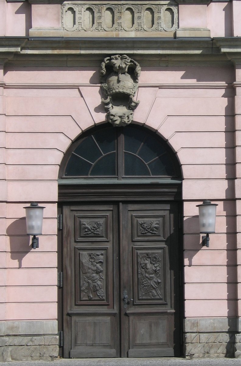 a doorway in an old building that has a stone lion head on it