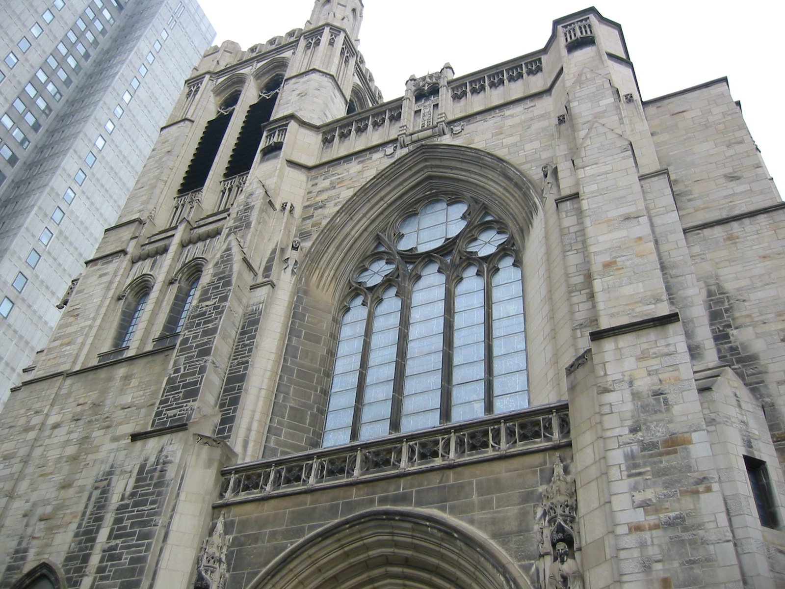 a tall church building has three different windows