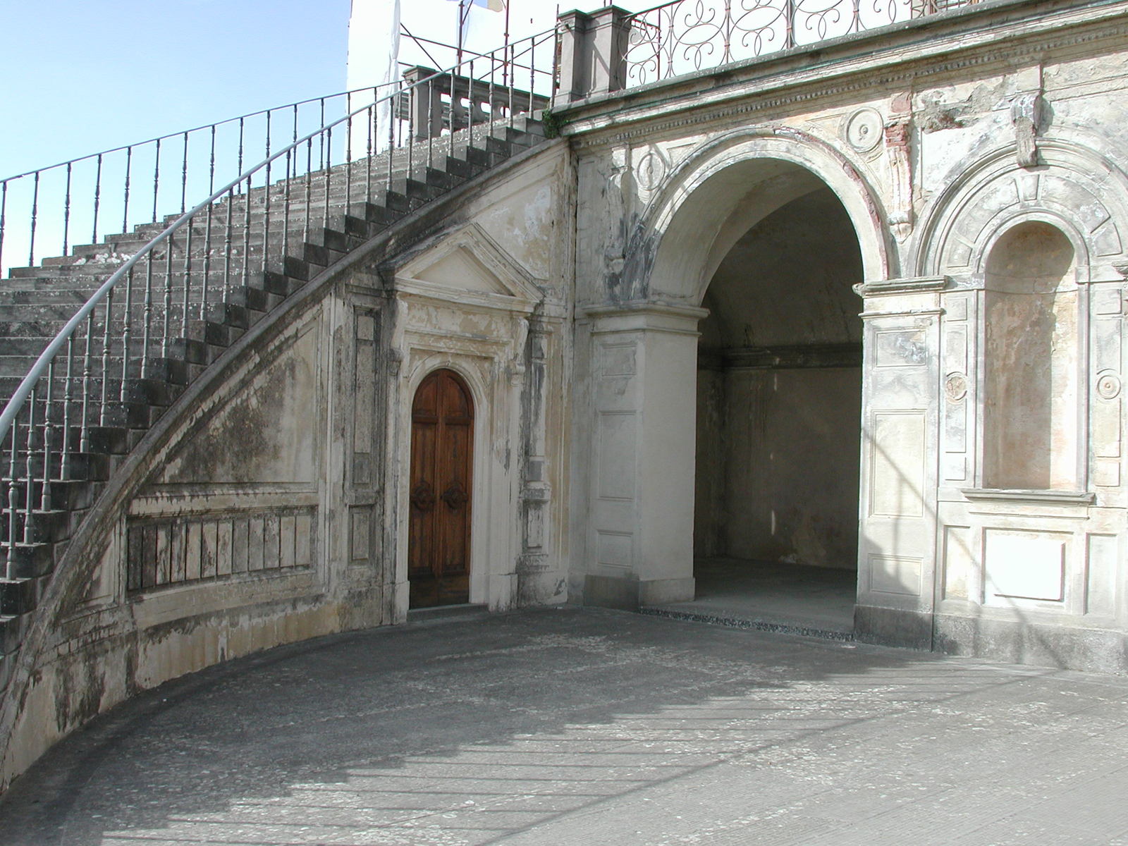 a stone entrance with steps and gated area