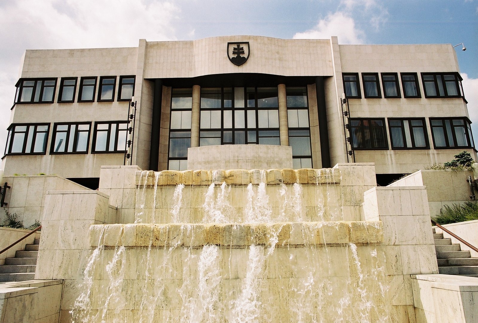 a large building with a fountain in front of it