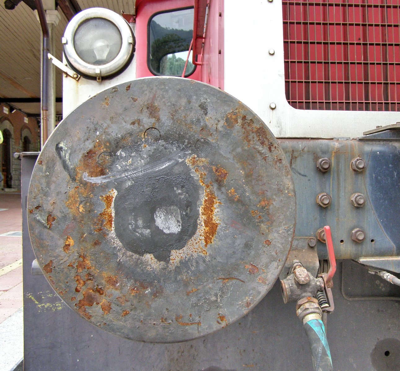 the flat bed of a vehicle, with a rusted metal disc