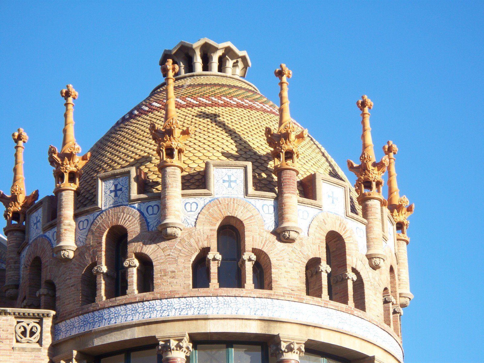 the top of an ornate building with golden roof, and clock on