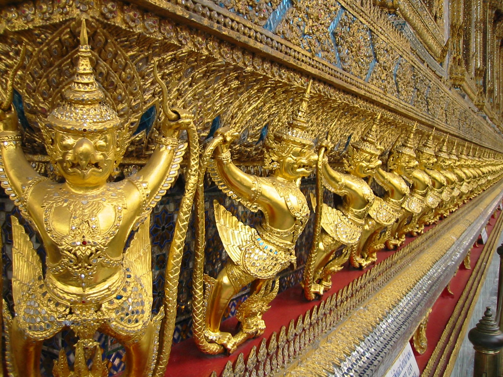 a lot of gilded gold statues with different designs on them