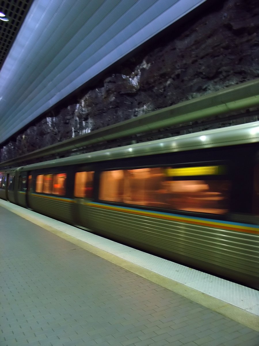 the blurry image shows a subway coming down the track