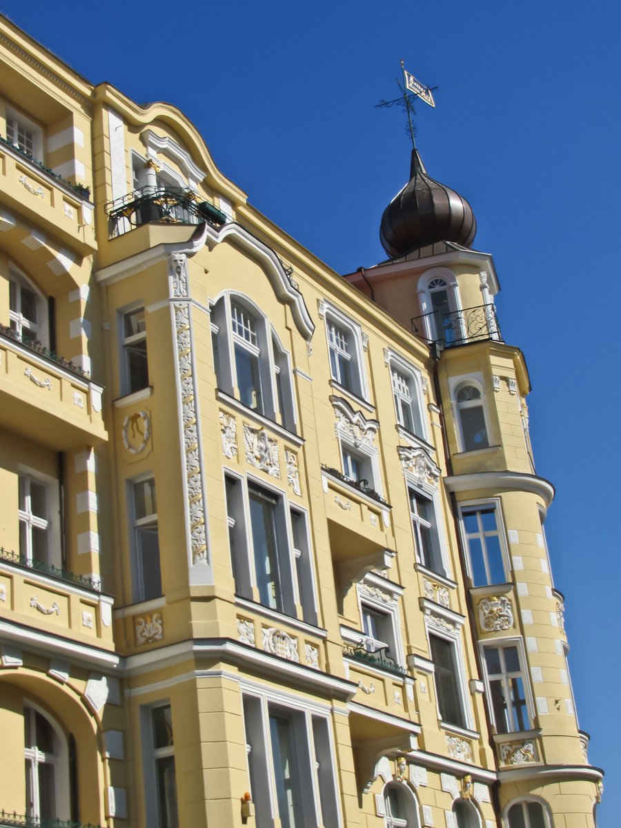 an ornate building with a bell tower on the roof