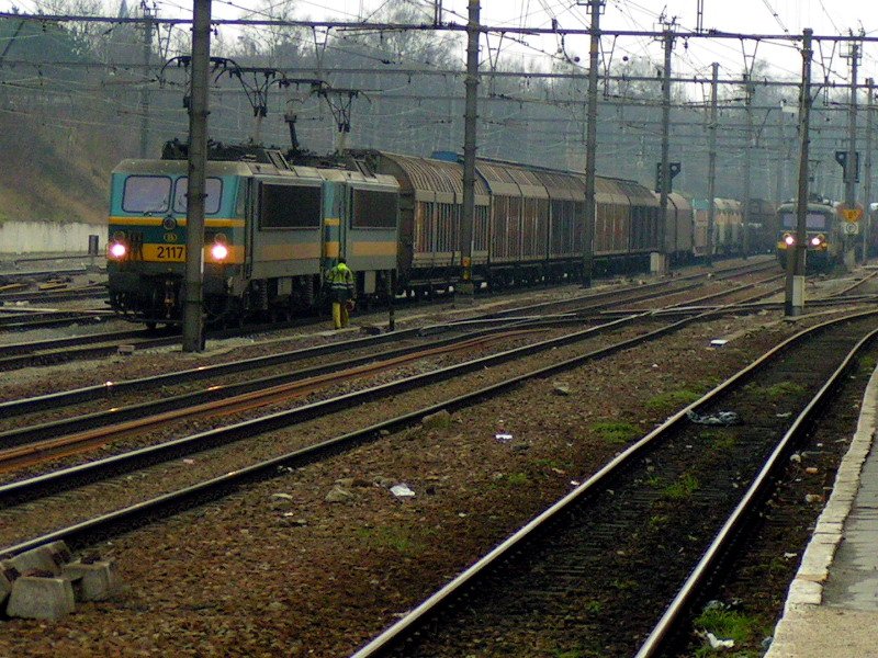 the train is travelling on the tracks near many other railroad tracks