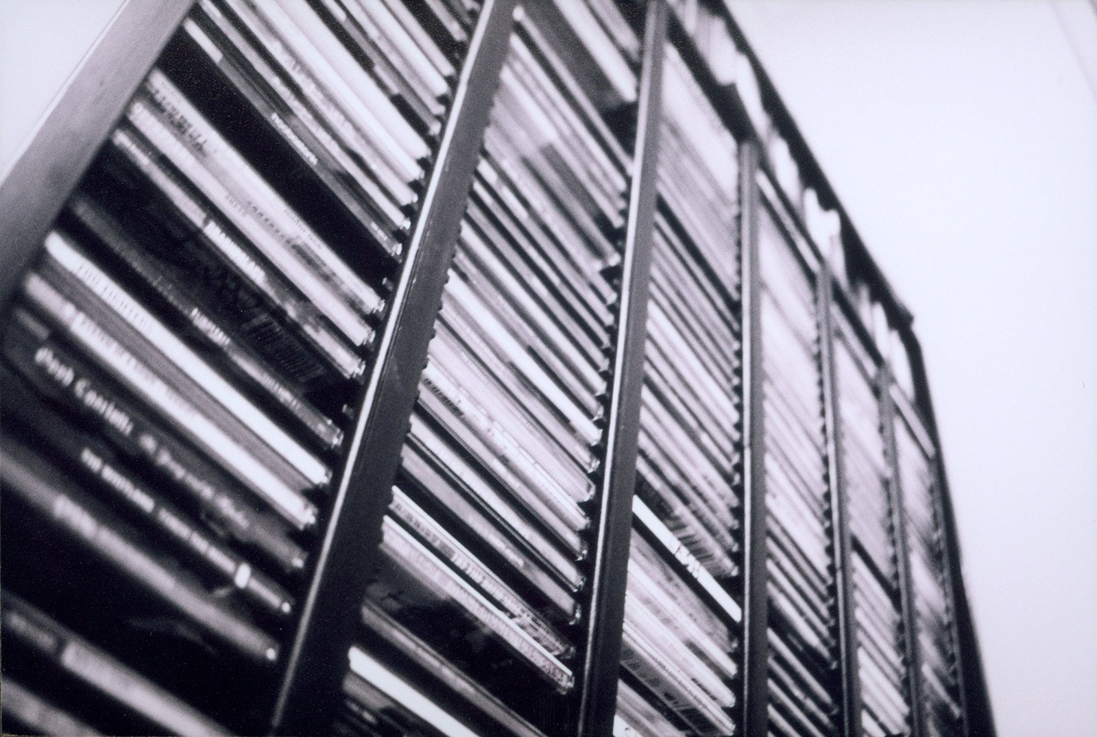 black and white pograph of a tall building with blinds