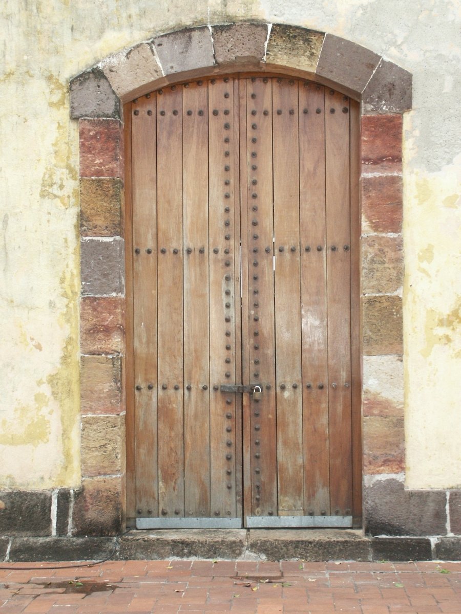 a brick area with a large wooden door