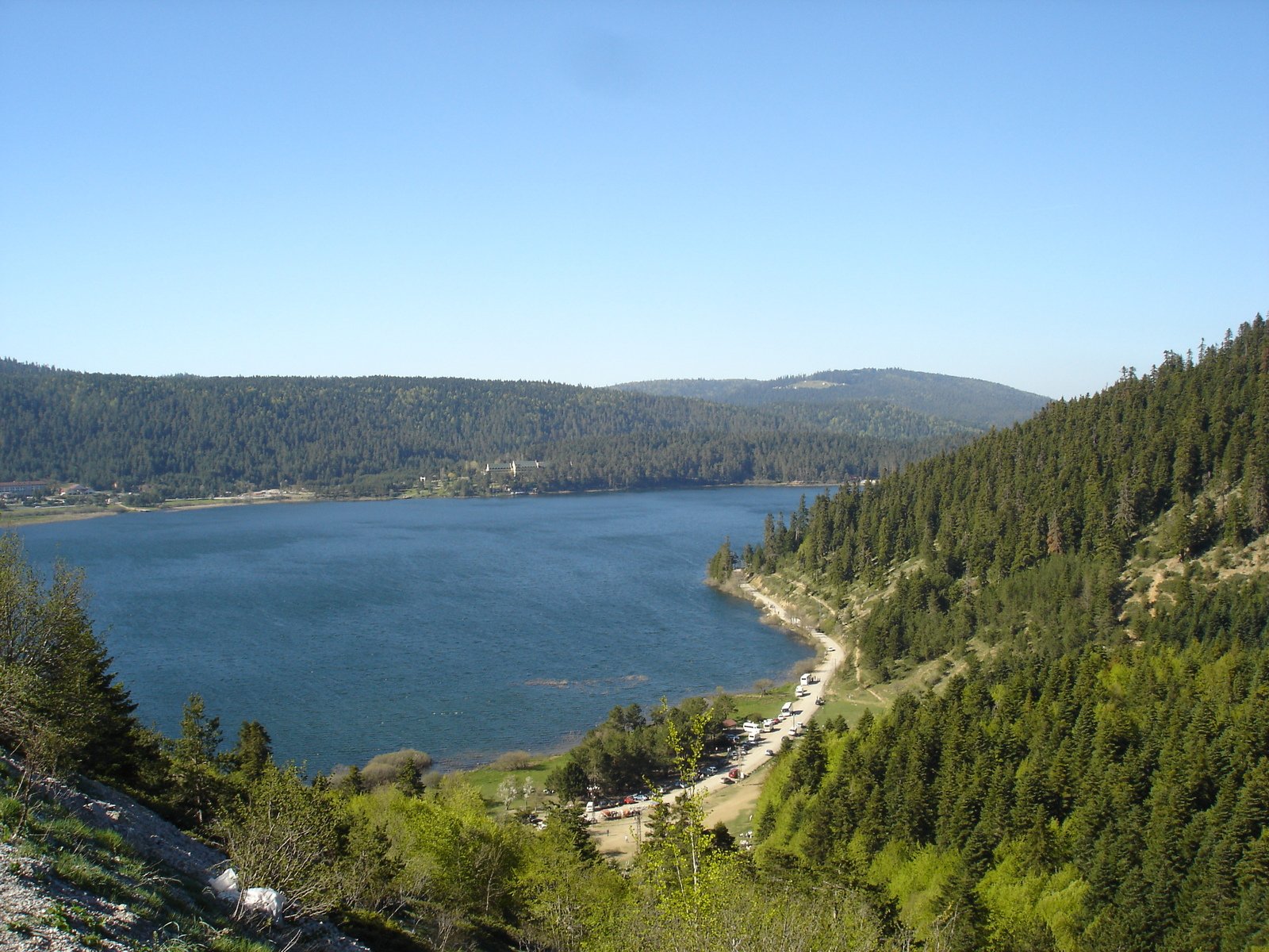 a large lake near many mountains and trees