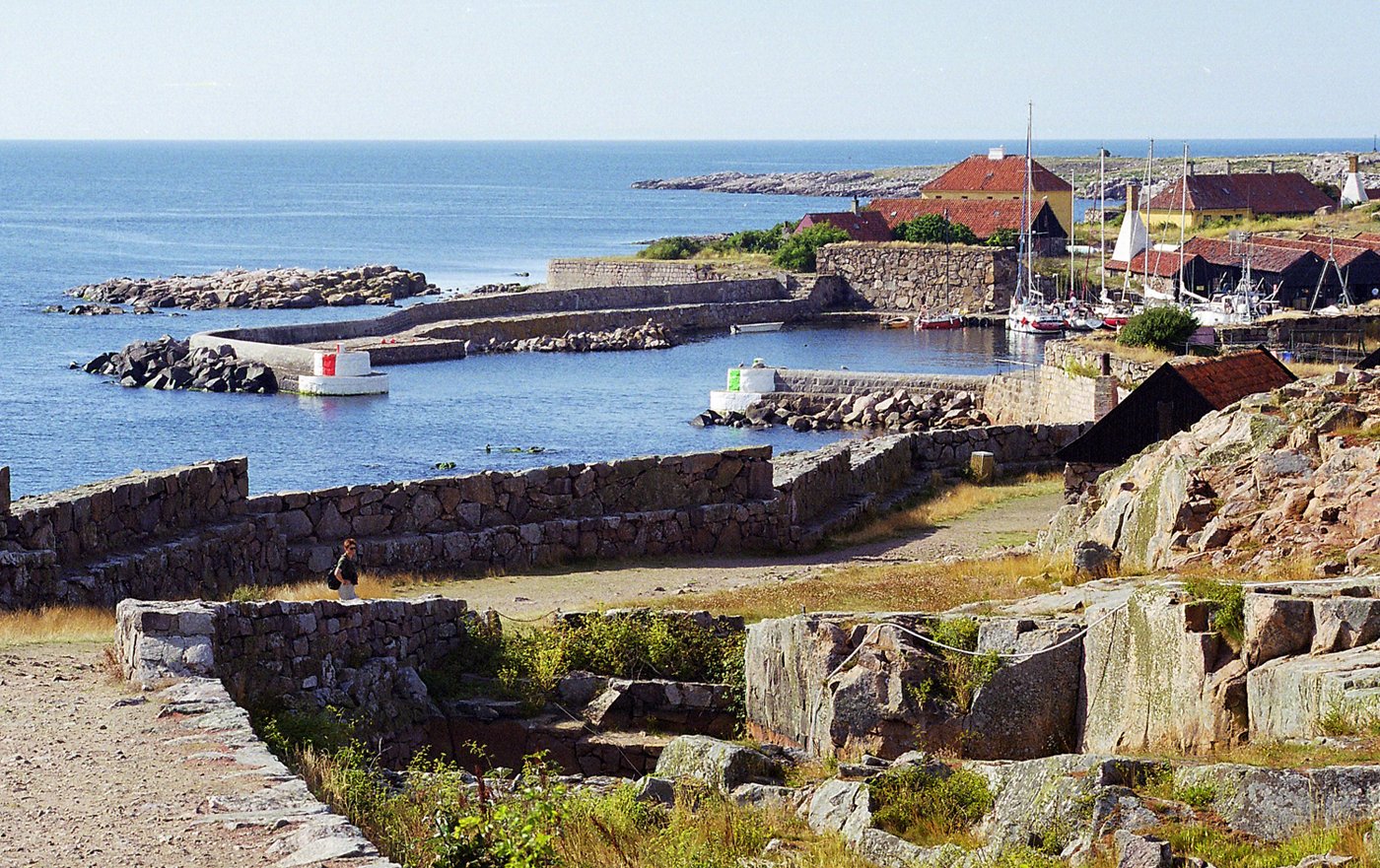 a small village by the sea where there are boats on the water