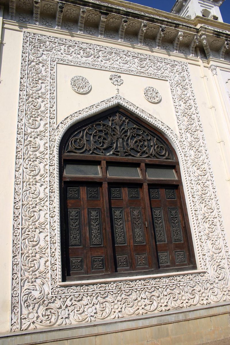 ornate wood doors and carvings on the wall of a building