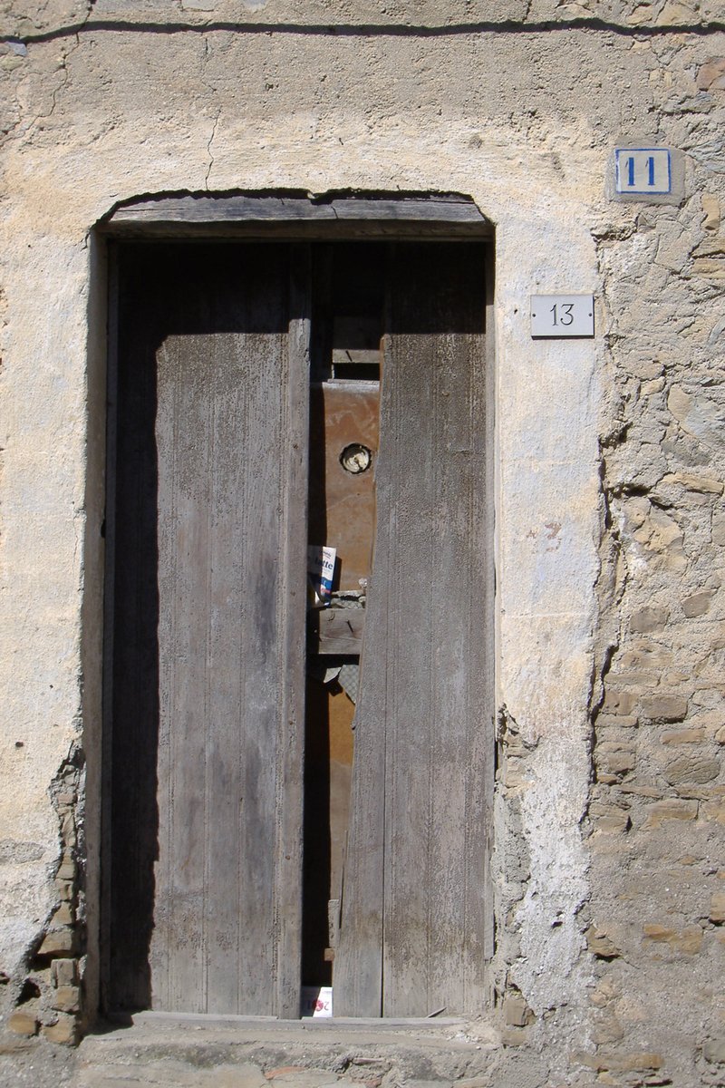 two wooden doors with a sign on them