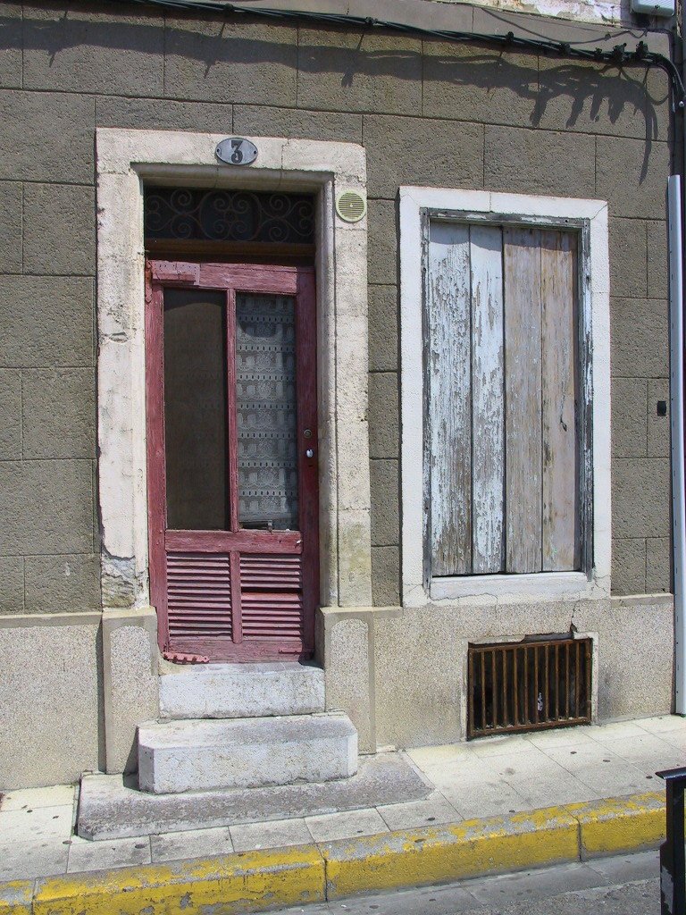 an old house with a window and doors